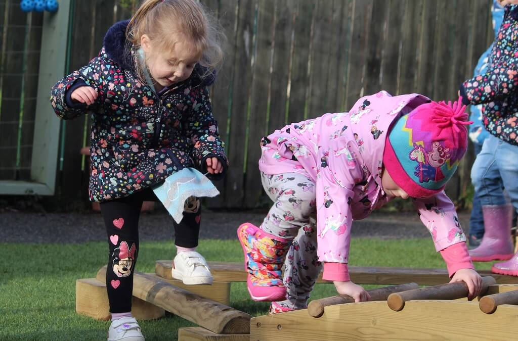 Children climbing in outdoor play area