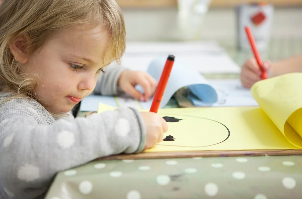 Child drawing in notebook