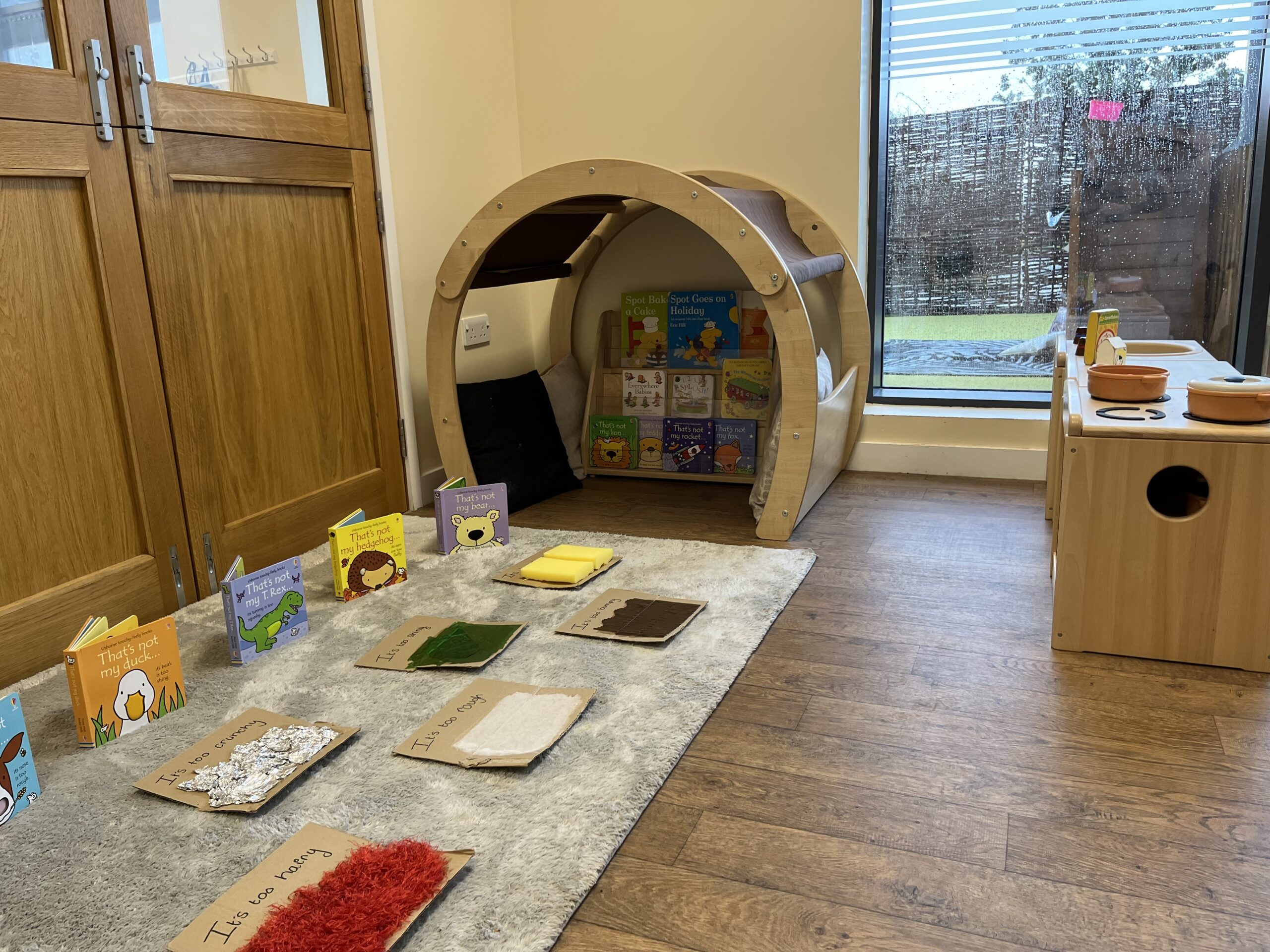 Lots of different textures laid out on carpet for babies to explore in the nursery