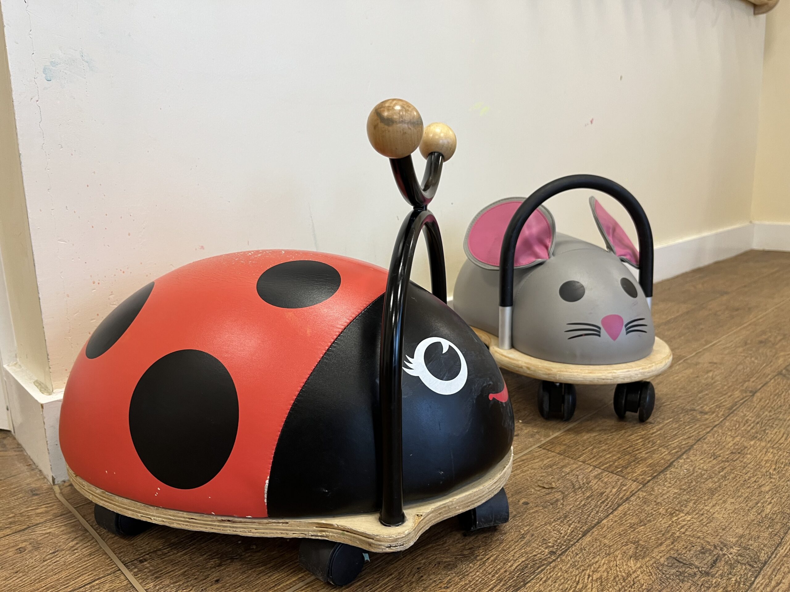 a lady bug and mouse with wheels to be used as a sit on and ride toy by children