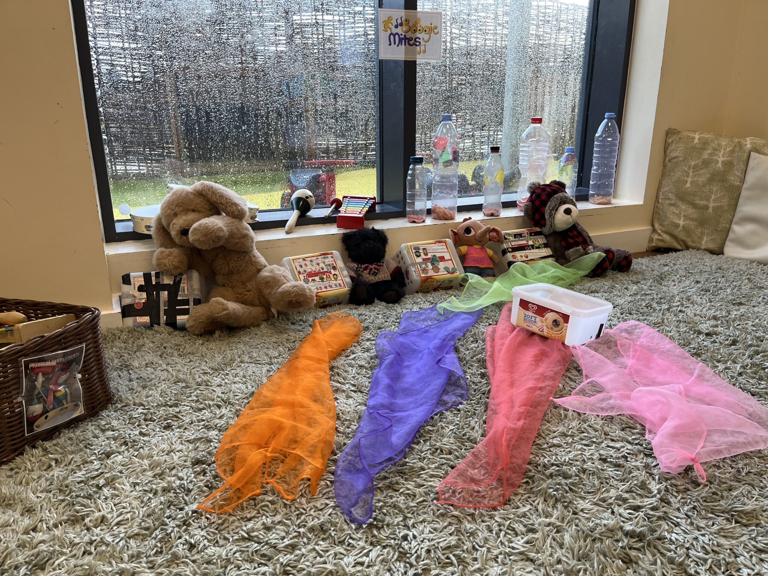 a corner of the room set up with bottle shakers and colourful ribbon for boogie mites sing and dance sessions