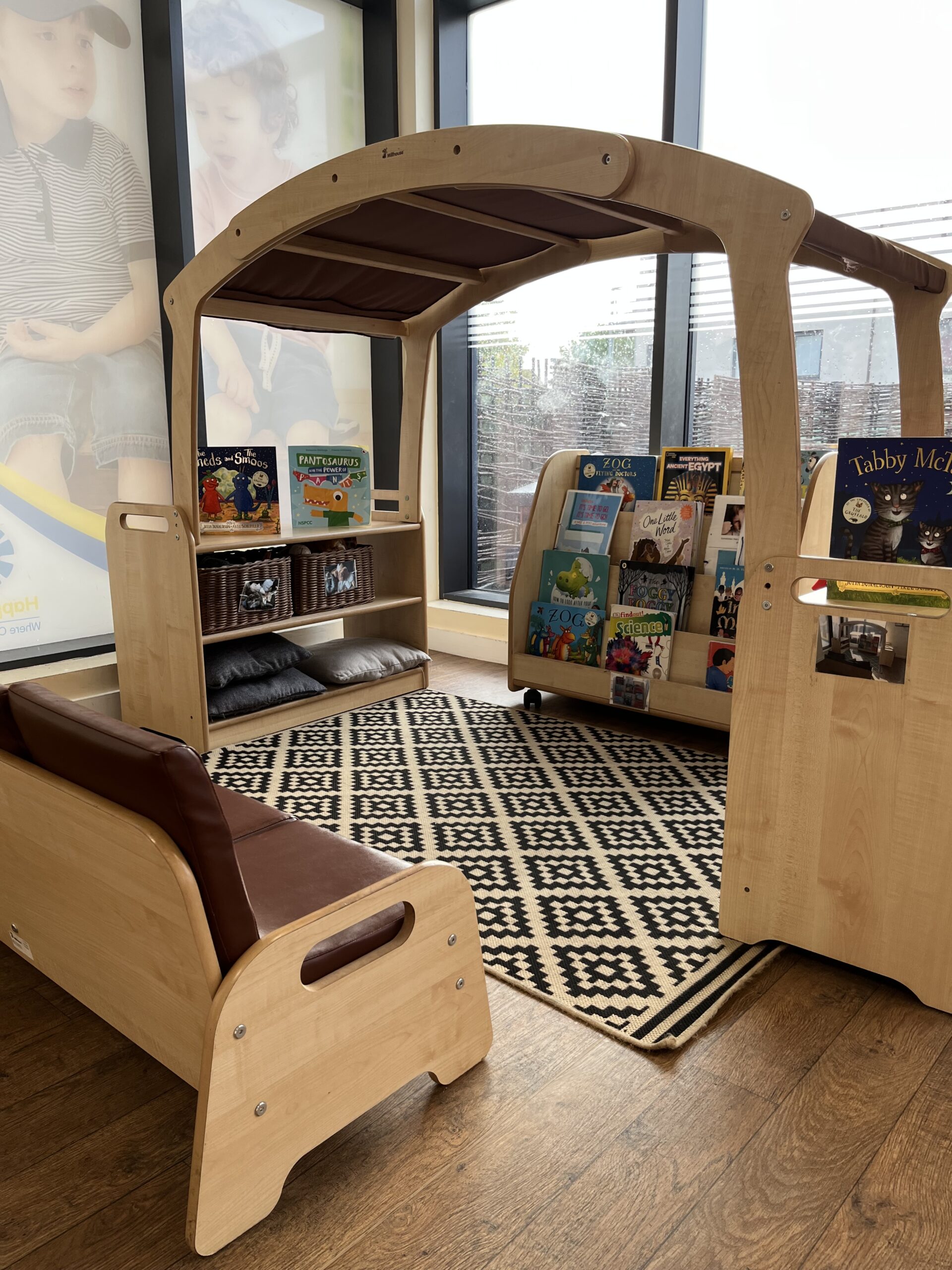 a cosy reading corner with a bookshelf filled with books and a comfy sofa to sit on