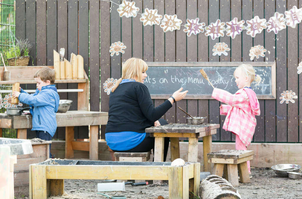Child drawing in outdoor play area