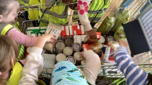 children helping to hand out the charlton heights food donation