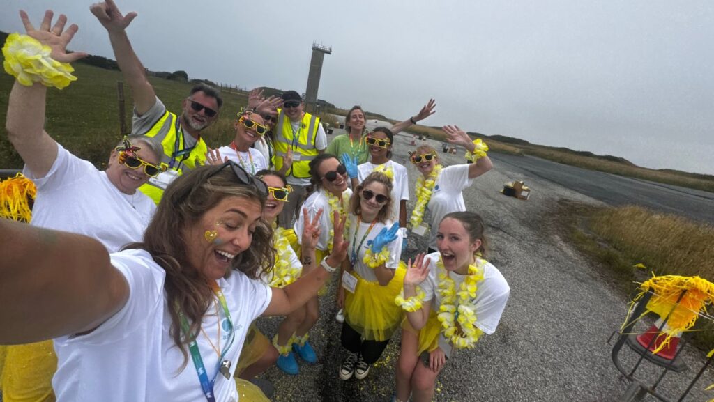 The yellow paint station team at Rainbow Run 2025