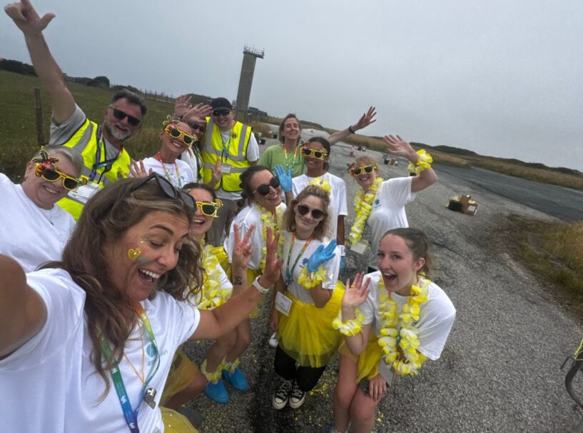 The yellow paint station team at Rainbow Run 2025
