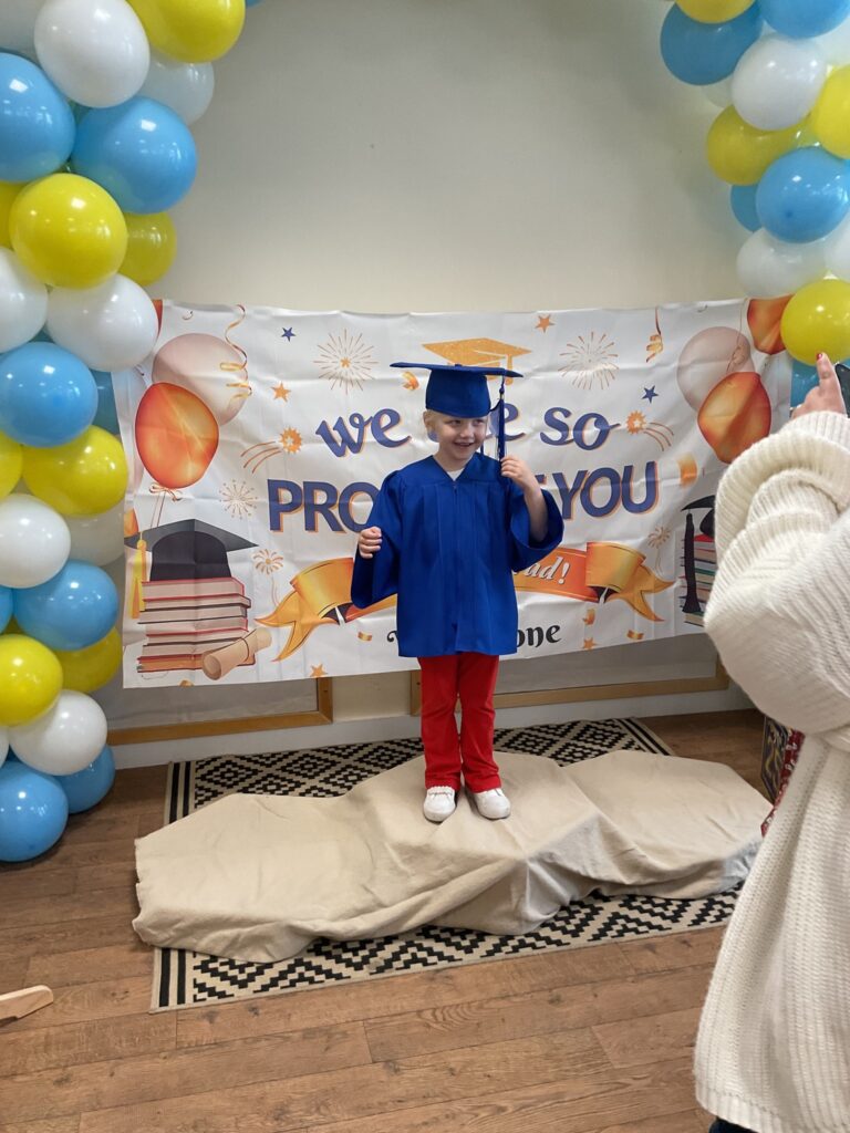 Child posing happy after graduating from pre-school