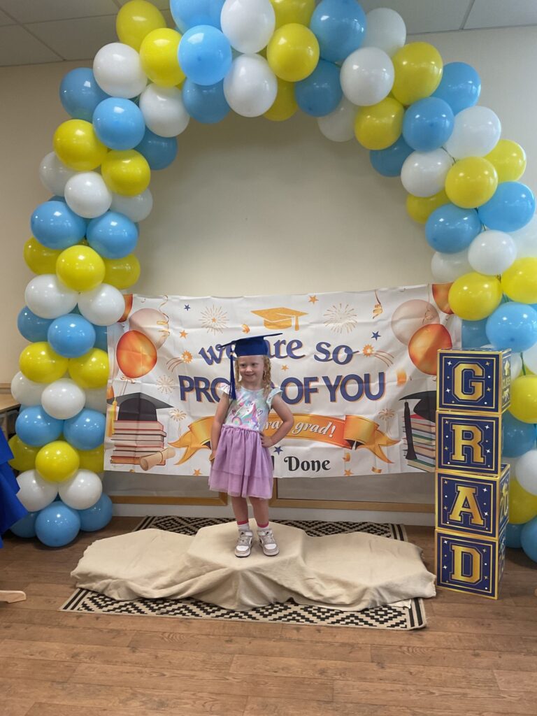 Child posing happy after graduating from pre-school