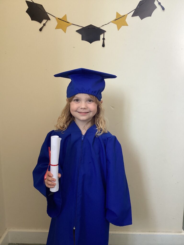 Child posing happy after graduating from pre-school