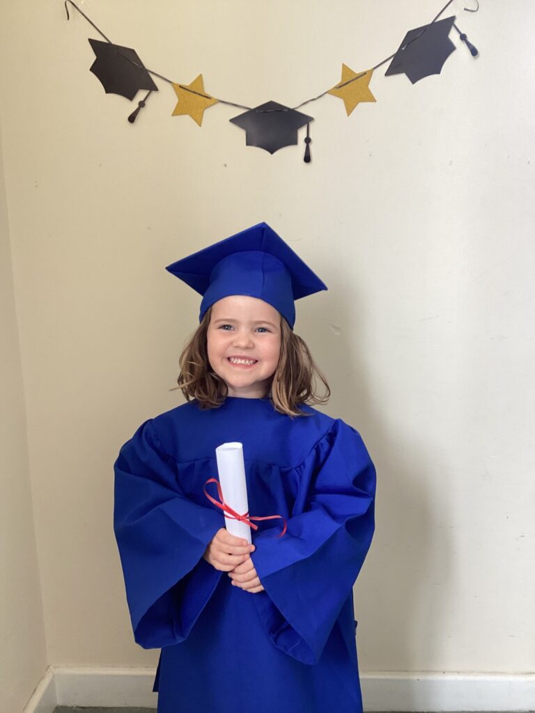 Child posing happy after graduating from pre-school