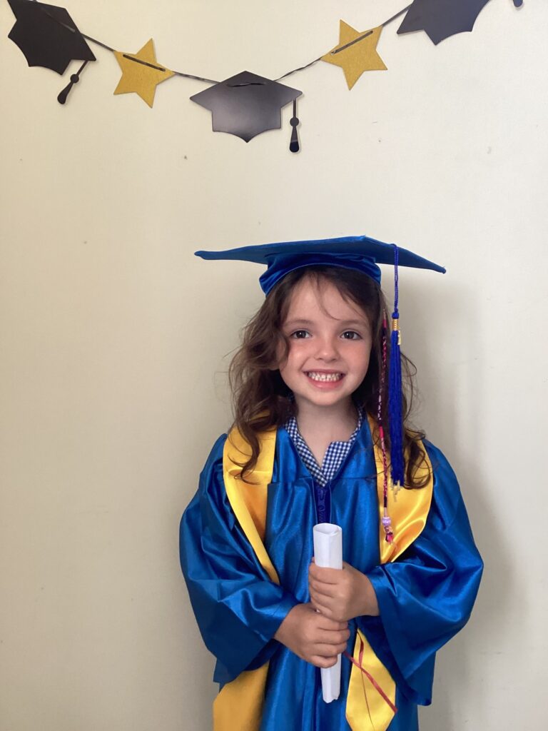 Child posing happy after graduating from pre-school