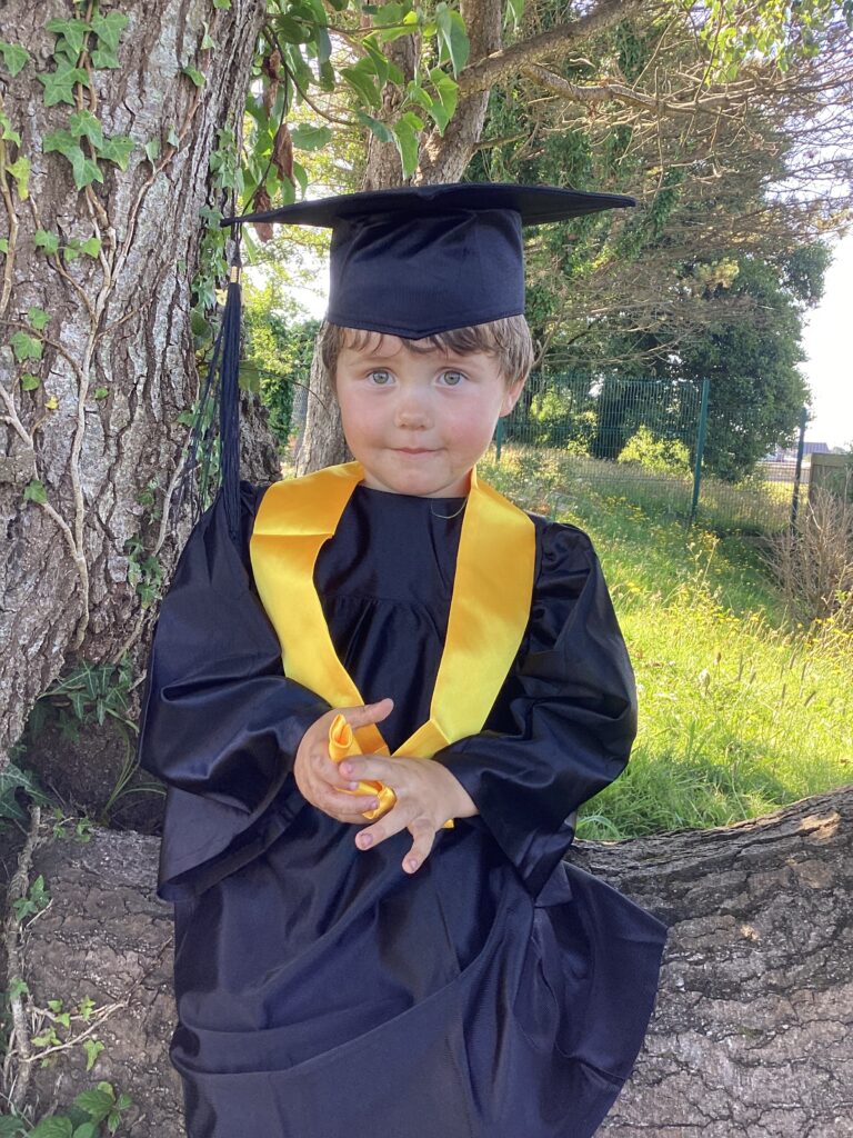Child posing happy after graduating from pre-school