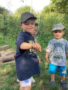Children in the garden with a butterfly at Happy Days Penair