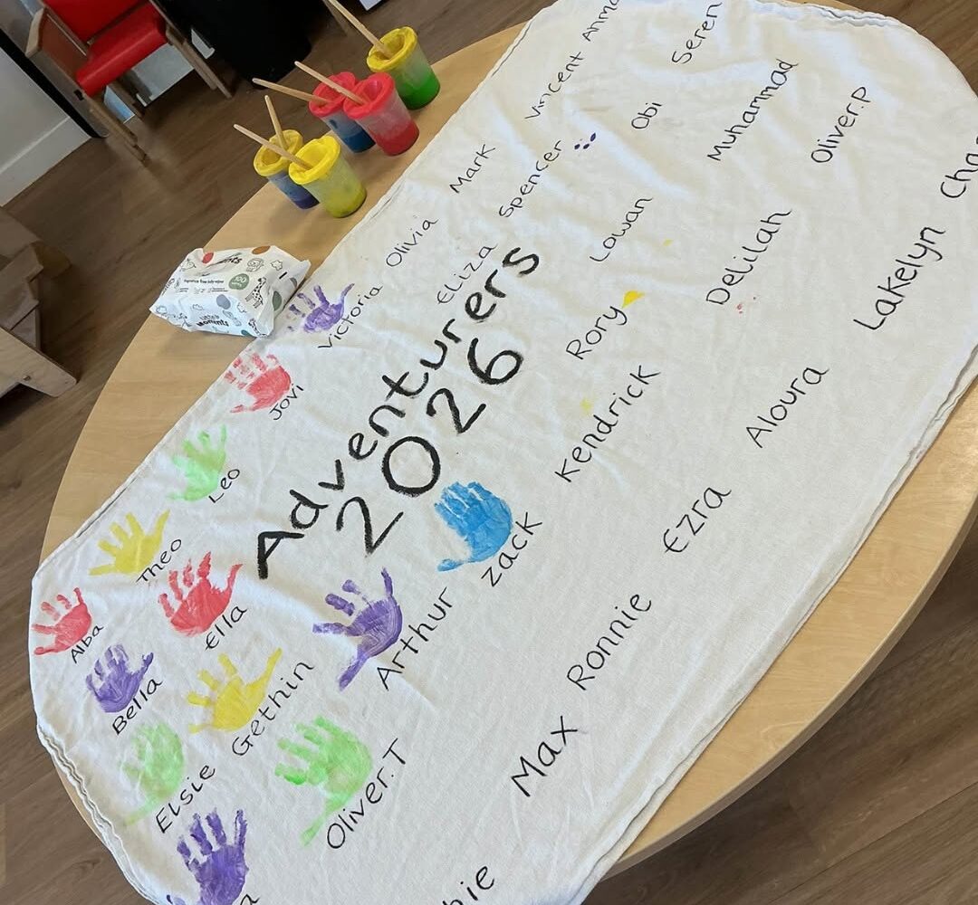 Graduation at Happy Days Yate. A banner with childrens handprints next to their names