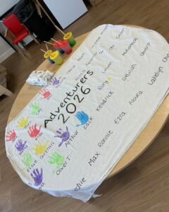 Graduation at Happy Days Yate. A banner with childrens handprints next to their names